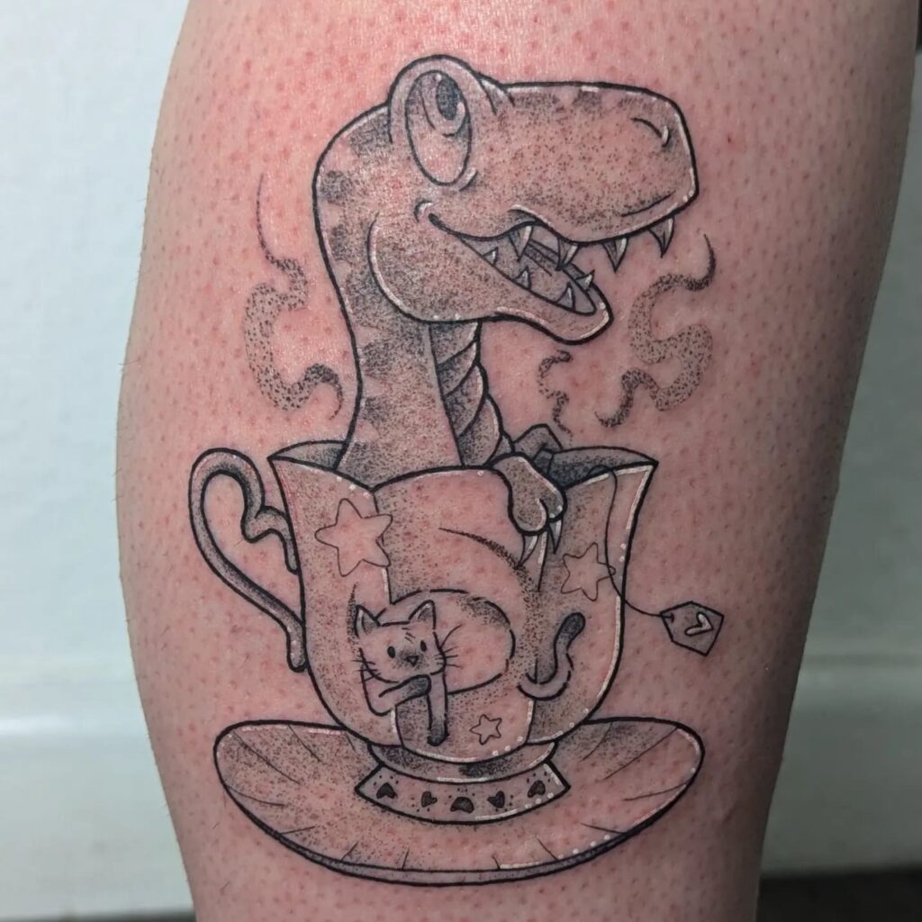 Josie Keable Dinosaur in a tea cup tattoo